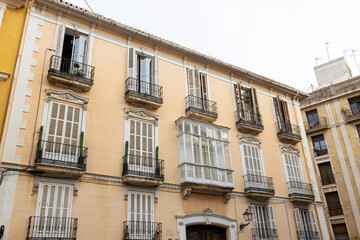 A street in the historical old town of Valencia. typical Spanish real estate blocks during a summer day