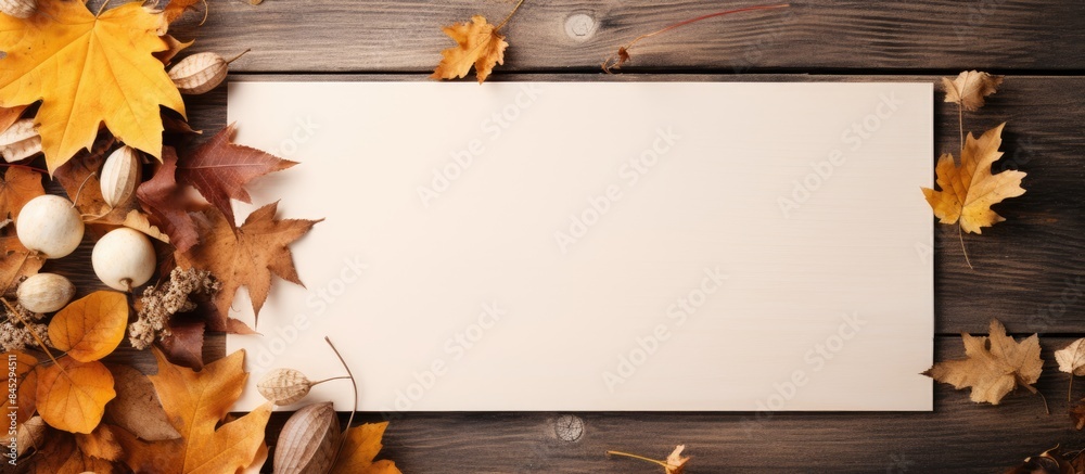Poster Square copy space image of an autumn themed flat lay composition with a paper card and dried leaves representing the concept of autumn fall and Thanksgiving Day