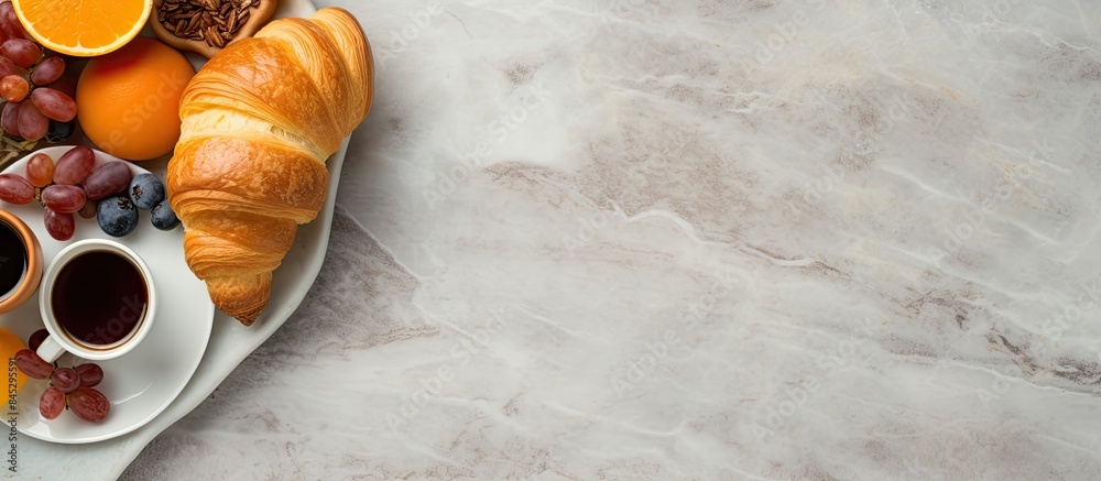 Poster top down view of a stone table adorned with breakfast essentials like coffee orange juice and a croi