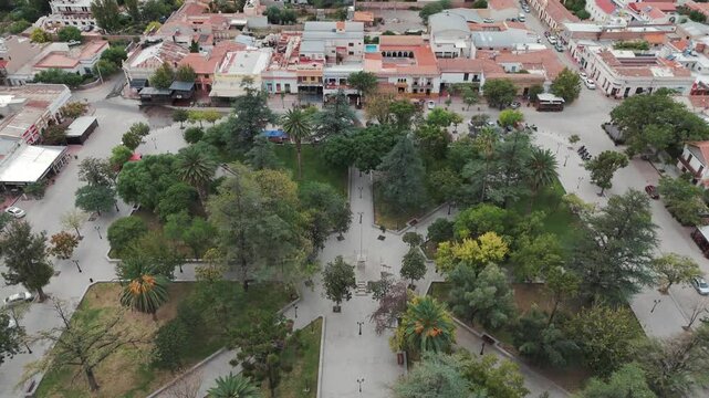 Top down drone shot of a green recreational park surrounded by urban houses in salta cafayate town of Argentina south america