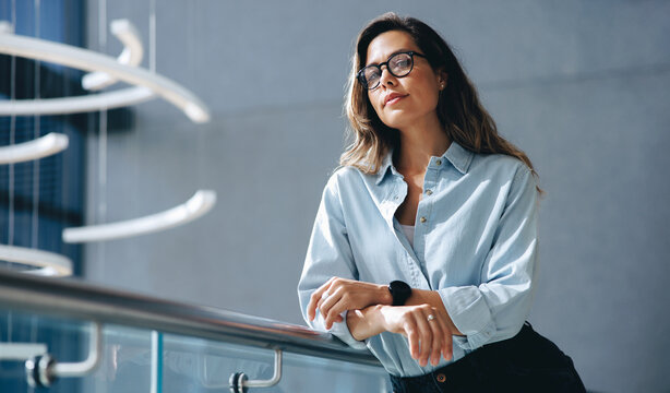 Confident business woman standing on a balcony in a business convention center
