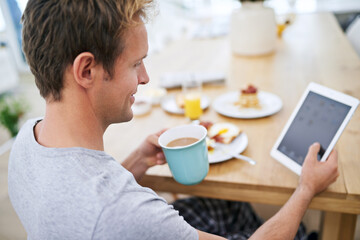Happy, man and morning with tablet at breakfast table for rest, home and entertainment on weekend or holiday at hotel. Coffee, male person and room service food with tech or social media or streaming