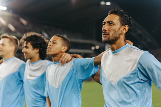 Professional football players lined up for national anthem before championship match