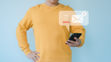 Man holding a mobile phone and viewing messages on mobile phone, Delete messages from a gang call...
