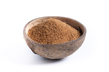 Coconut palm sugar in coconut bowl isolated on white background.