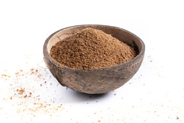 Coconut palm sugar in coconut bowl isolated on white background