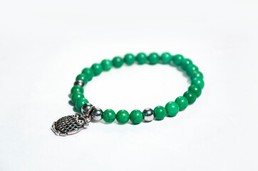 Green necklace  with natural stones with silver owl pendant on white background