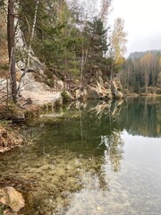 A stunning azure lake nestled amidst towering rocky cliffs and majestic firs.

