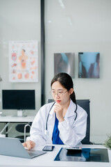 Beautiful physician doctor sit on table in office hospital. Attractive therapist female...