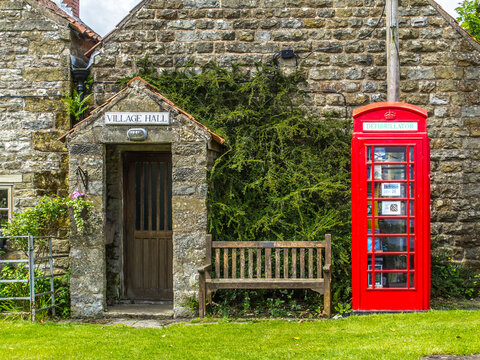 Levisham village hall North Yorkshire red defibrillator reuse telephone box and bench