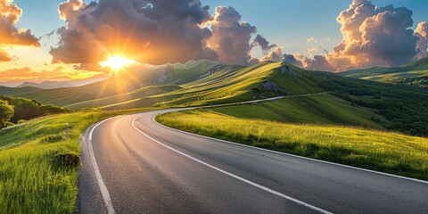 Empty highway in the beautiful mountains, sky illuminated by the sun's rays at sunset, incredible nature, bright saturated colors