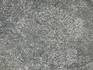 A grey and white background with a few small black dots