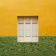 White window with on building with colorful yellow and green wall. Front view minimal vacation travel concept.