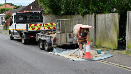 Tradesmans van and trailor illegally parked on the pavement in the UK. 