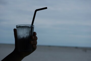 hand holding a glass of water