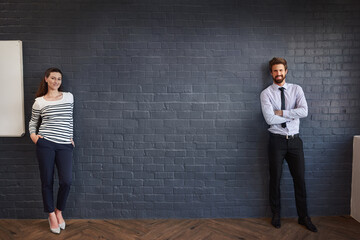 Obraz premium Business people, portrait and wall with team in boardroom for presentation, coaching or conference at office. Creative man, woman or presenter in confidence for mockup space, communication or startup