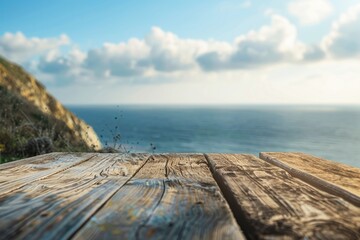 Wooden table with blurred background of sea and sky.