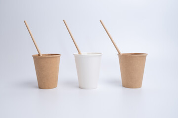 Top view of brown kraft paper cups, straws on a white background. Recyclable street food packaging....