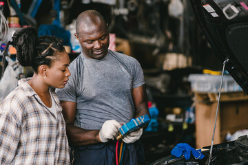 Mechanic man talking with customer inform explain car air condition low liquid problem, service detail in garage.