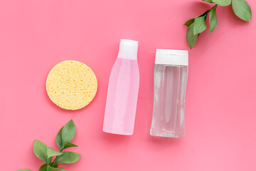 Organic cosmetics for face clearing with sponge, facial tonic and mycelial water on pink background...