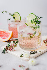 pink fresh cocktail with grape-fruit and cut lime on stone desk background