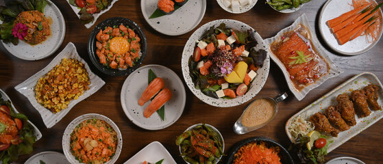 Top view of various traditional Japanese food dishes on wooden table