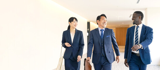 Group of multinational business people walking and talking inside a building