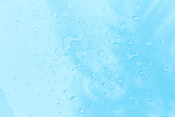 Water drop on blue background, water splash on clear blue background