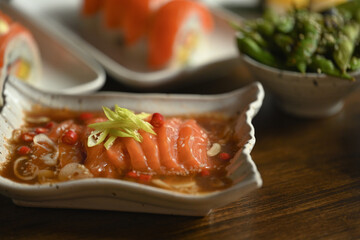 Pickled salmon in shoyu sauce or soy sauce with chili and garlic in ceramic plate. Asian food style