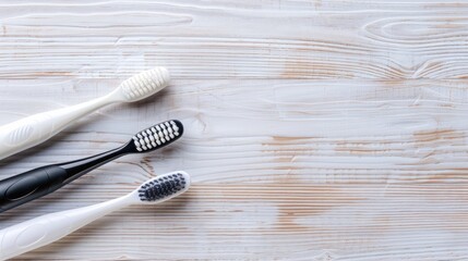 Electric and manual toothbrushes on light wooden background with space for text Top view