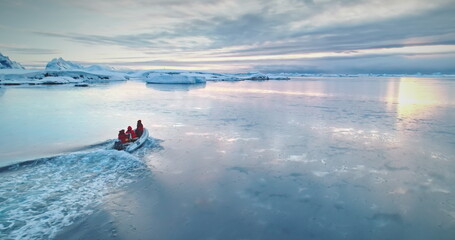 Antarctica travel and exploration, people riding motor boat. Zodiac boat sailing cold polar ocean...