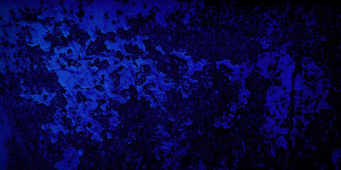 Close-up of a rusted metal surface with peeling paint, illuminated by a deep blue gradient against a black background. The texture of corrosion and decay creates an intricate pattern