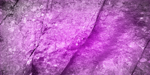 A bright purple textured rock surface creating a striking and vibrant background. Ideal for design projects needing a bold and unique aesthetic with a natural stone pattern and vivid coloration