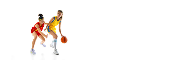 Fototapeta premium Banner for sport event announcement. Two women, basketball players in motion during game, isolated on white studio background. Concept of sport, active lifestyle, competition, game, dynamics.