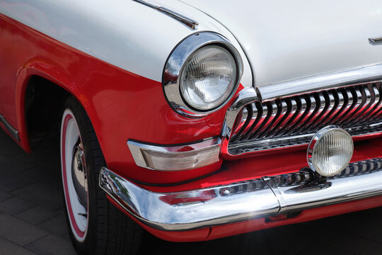 Close-up of the front of a beautiful blue car. Exhibition of retro cars from the 60s in the city street.