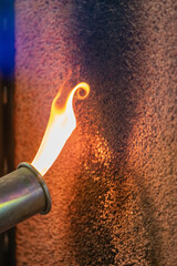 Close up of a flame torch testing flame retardant material, demonstrating fire resistance and...