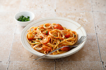 Homemade pasta with tomatoes and squid