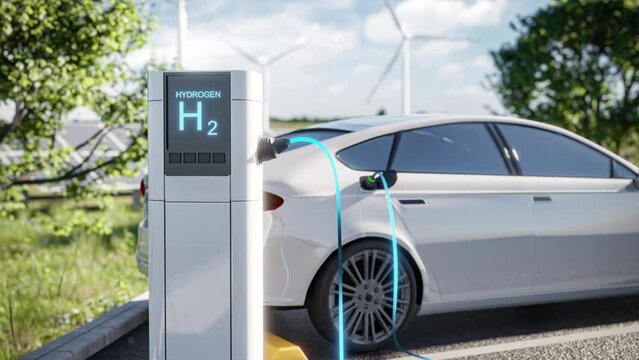 Electric car charging at a hydrogen station, set against a green environment with wind turbines in the background. The footage depicts modern, eco-friendly transportation technology.