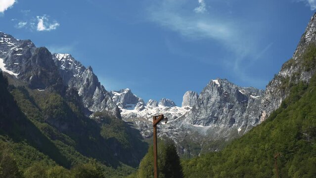 A majestic mountain range looms in the background, with the distinctive Microsoft logo prominently displayed in the foreground