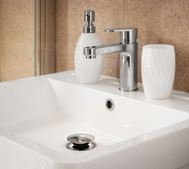 Bathroom sink - Modern style faucet with tiled backsplash with handwash dispenser. Empty white vanity counter with ceramic washbasin.