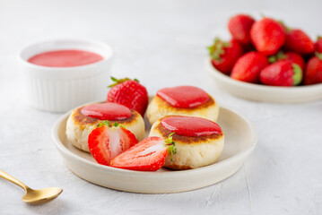 Vegan cheesecakes, syrniki, cheese pancakes with strawberries, jam, cashew and tofu. Sugar, lactose and gluten free.
