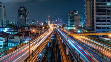 Fototapeta premium road and the light trails of sky train at night