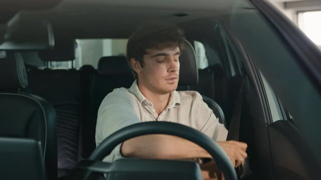 Happy Caucasian business man driver sit in car male guy businessman fasten seat belt smiling rejoice buying new automobile rent auto prepare for driving at parking lot salon rental service test drive
