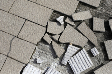 Cracked brown tiles on cement floor