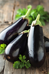 Three plump, glossy eggplants, their dark purple skin glistening with moisture, rest on a rustic wooden surface, adorned with sprigs of fresh parsley.