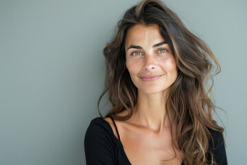A close up portrait of a woman with a subtle smile