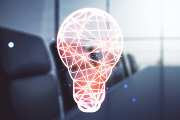 Abstract virtual light bulb hologram on a modern boardroom background, idea concept. Multiexposure