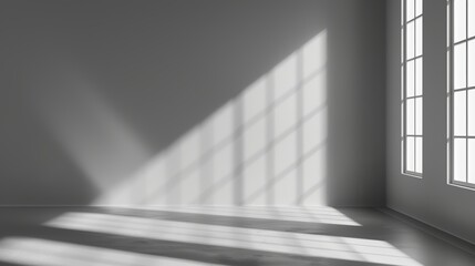 A gray background for product presentation, featuring shadows and light streaming in from windows.