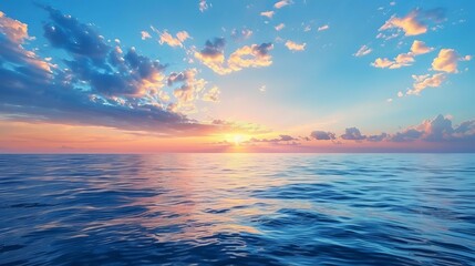 Fototapeta premium A nature background featuring a sunset with a blue sea and sky adorned with clouds.
