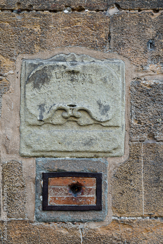 Wall mural close-up of a 17th century alms-box on the facade of the torre dei mannelli, a small tower on the so